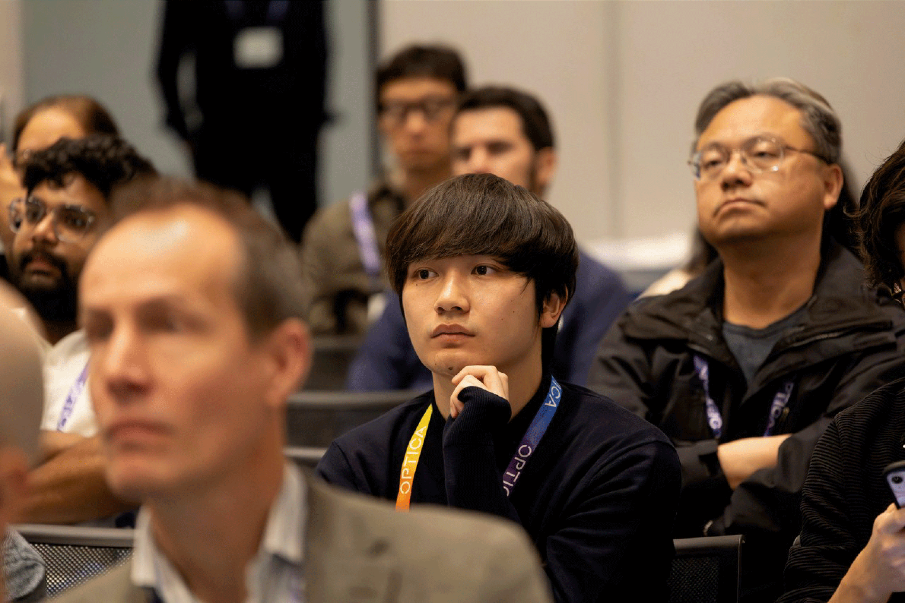 Conference attendees listen attentively to a presentation at FiO.